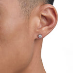 Model wearing white gold moissanite earrings by Iceman Society