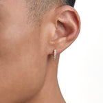 Model wearing 18k gold diamond earrings by Iceman Society
