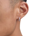 Model wearing white gold diamond earrings by Iceman Society