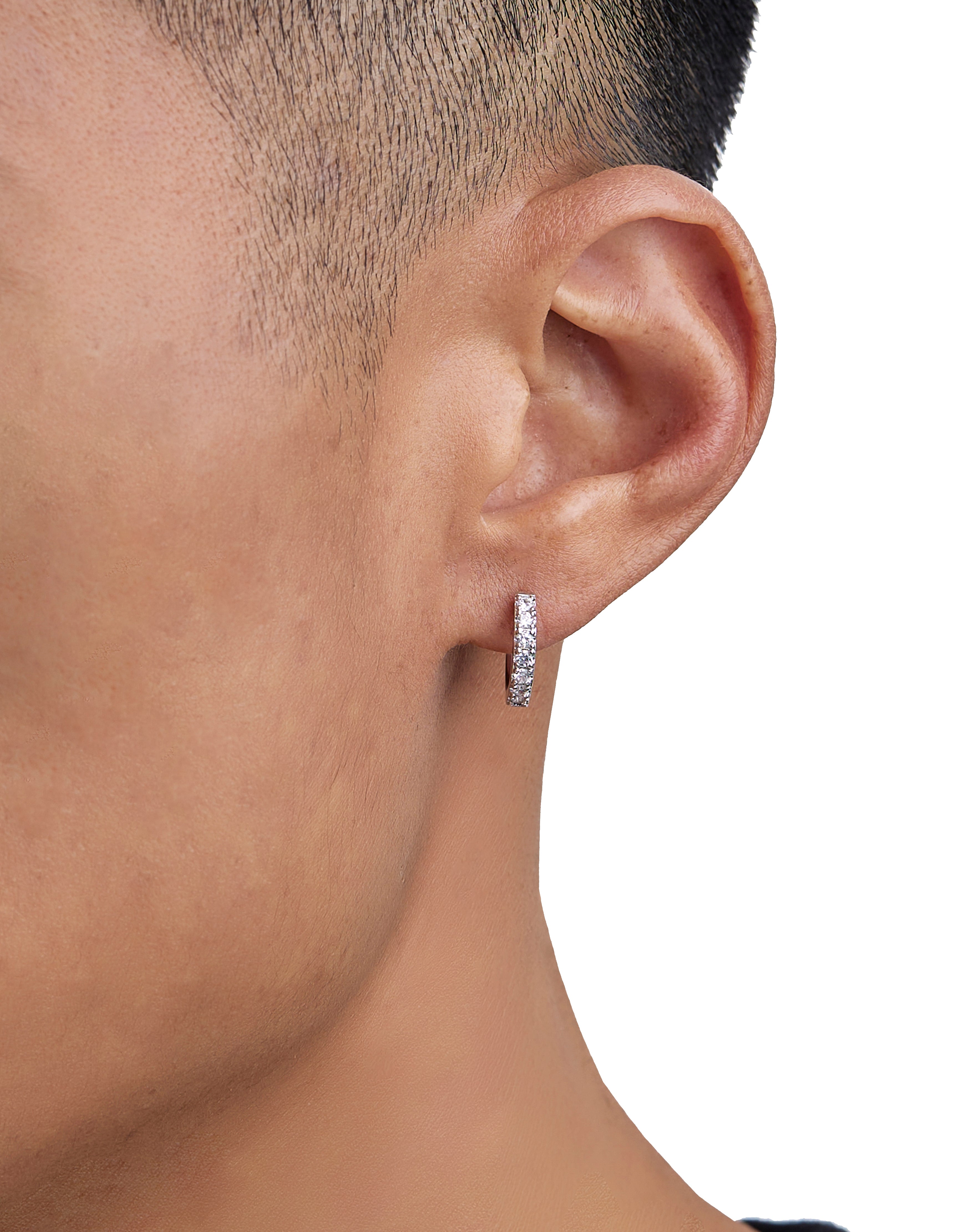 Model wearing white gold diamond earrings by Iceman Society