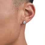 Model wearing white gold diamond earrings by Iceman Society