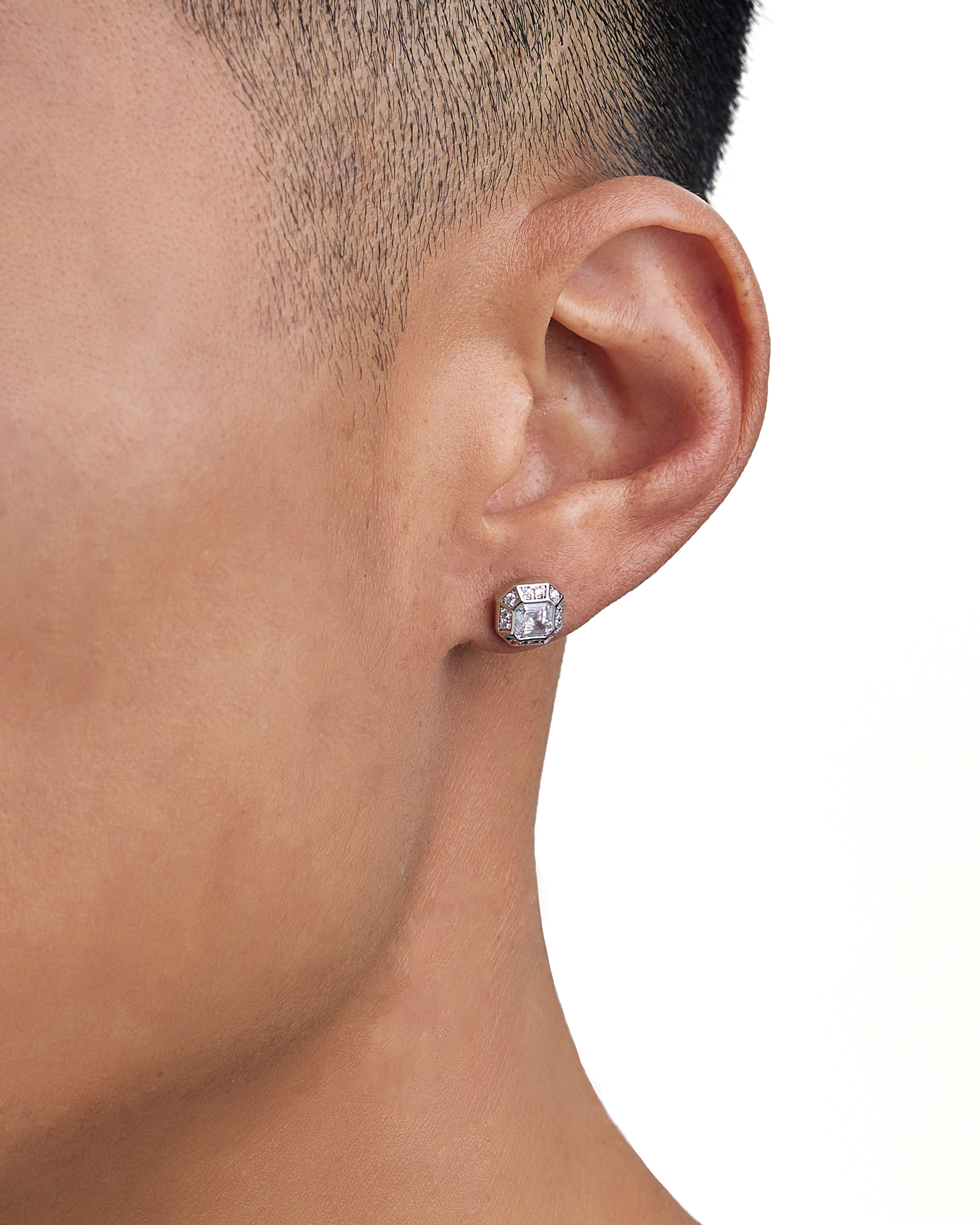 Model wearing white gold diamond earrings by Iceman Society