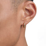 Model wearing 18k gold earrings by Iceman Society