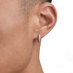 Model wearing white gold diamond earrings by Iceman Society