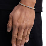 Model wearing 4mm 18k gold tennis bracelet by Iceman Society