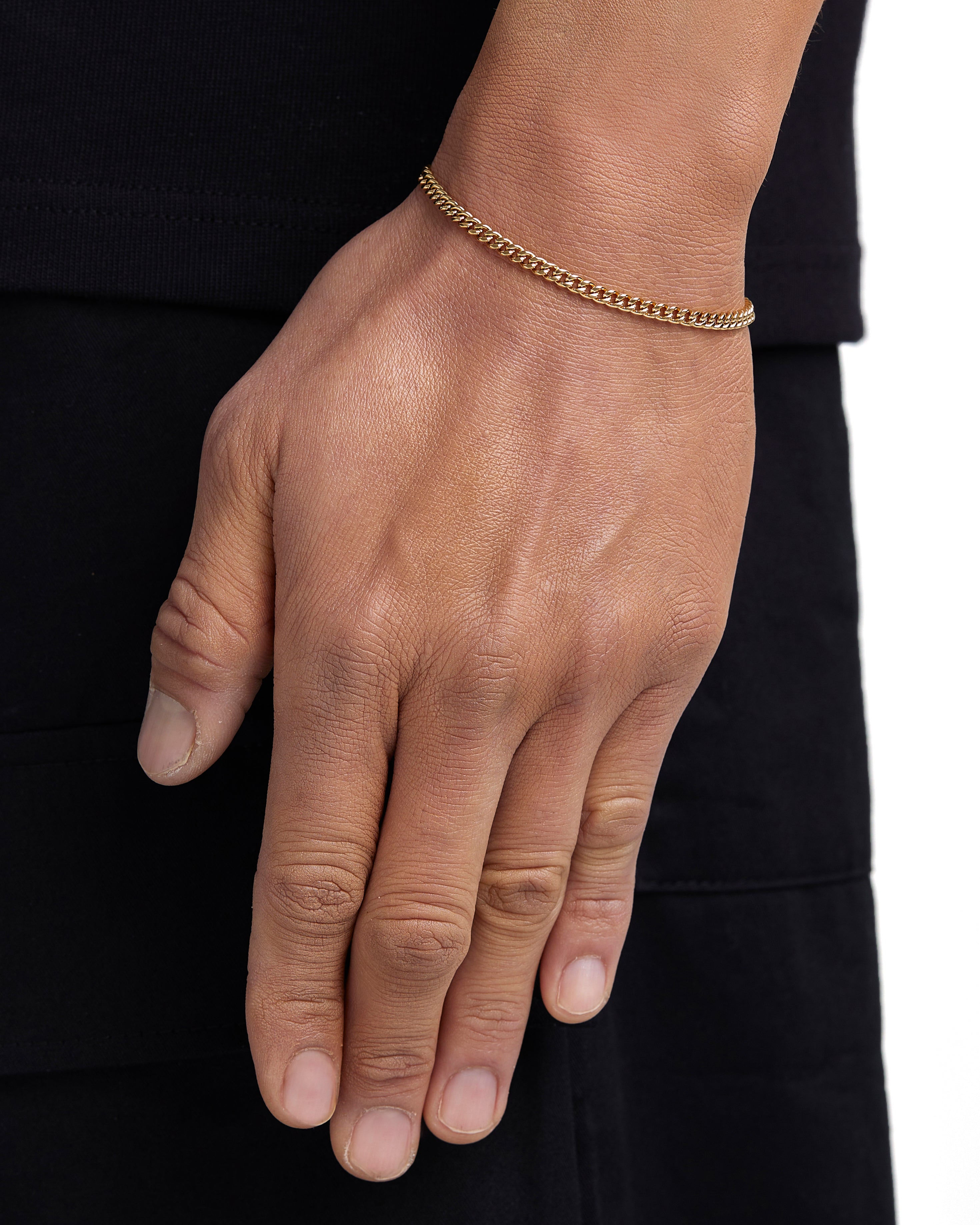 Model wearing 3mm 18k gold plain cuban bracelet by Iceman Society