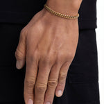 Model wearing 5mm 18k gold plain cuban bracelet by Iceman Society