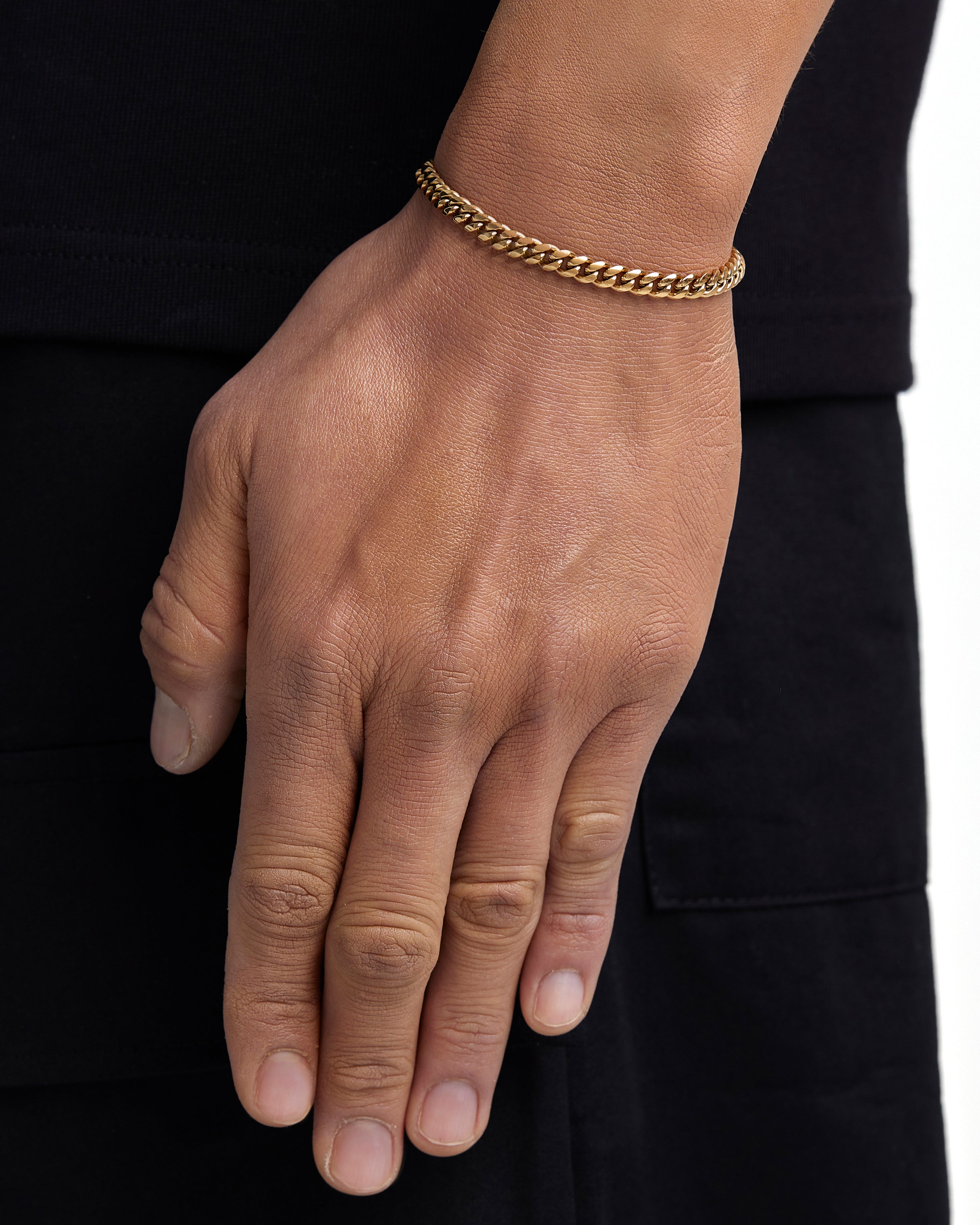 Model wearing 5mm 18k gold plain cuban bracelet by Iceman Society