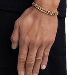 Model wearing 8mm 18k gold plain cuban bracelet by Iceman Society